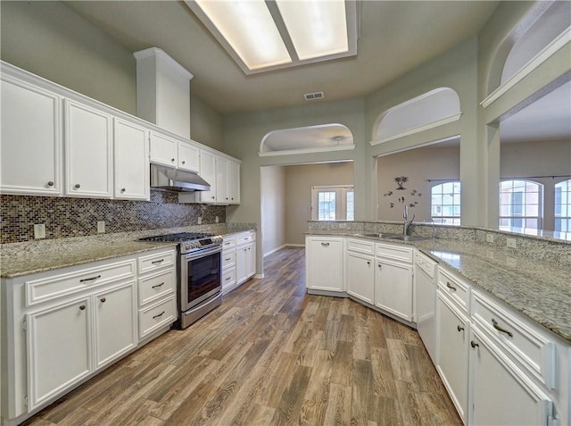 kitchen featuring white cabinetry, sink, and stainless steel gas range oven