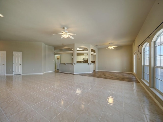 spare room featuring light tile patterned floors and ceiling fan