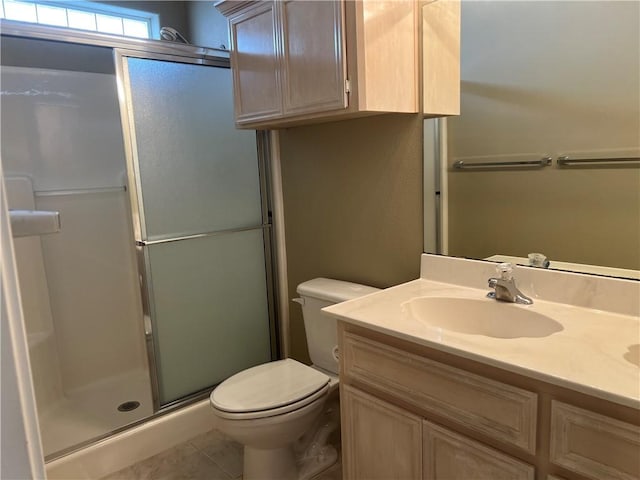 bathroom with vanity, tile patterned floors, toilet, and walk in shower