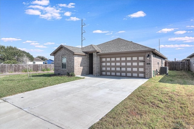 view of front of home with a garage, a front yard, and central air condition unit