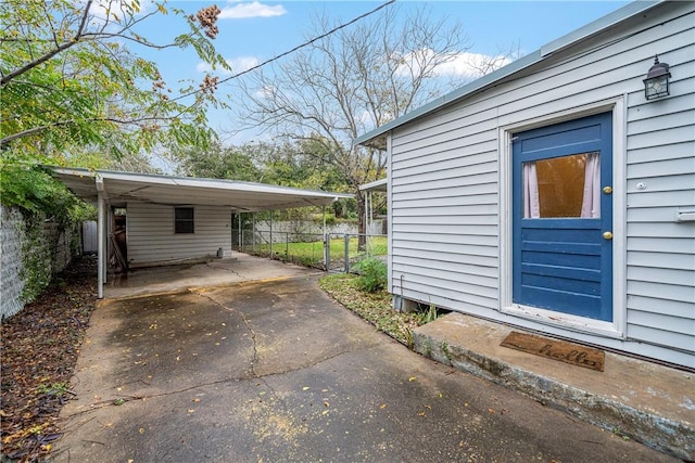 view of side of property with a carport