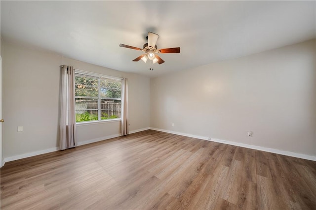 empty room featuring ceiling fan and light hardwood / wood-style flooring