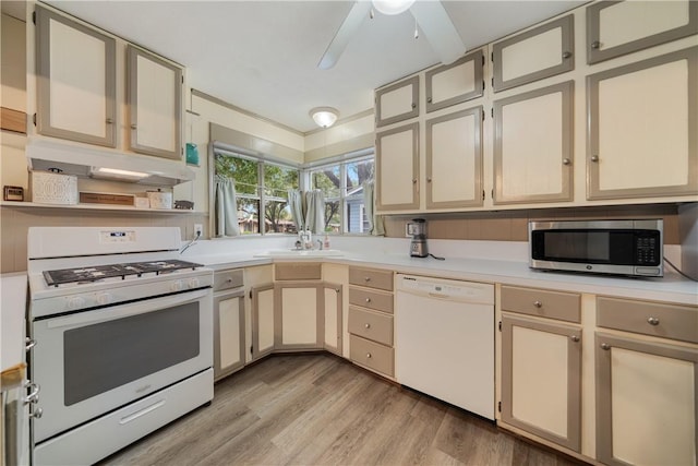 kitchen with white appliances, cream cabinets, light hardwood / wood-style flooring, ceiling fan, and sink