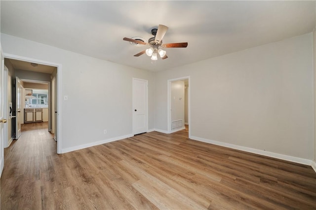 unfurnished room featuring ceiling fan and light hardwood / wood-style flooring