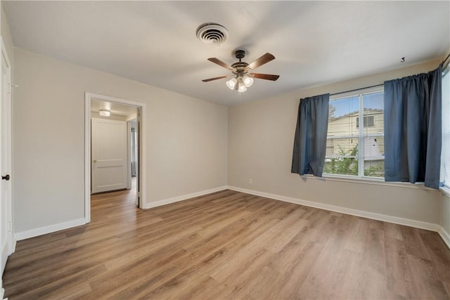 empty room featuring light wood-type flooring and ceiling fan