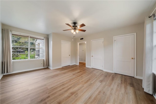 unfurnished bedroom with ceiling fan and light hardwood / wood-style flooring