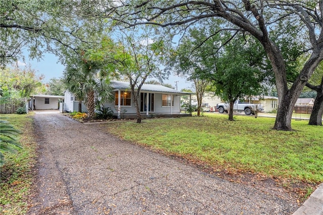 ranch-style home with a front yard and covered porch