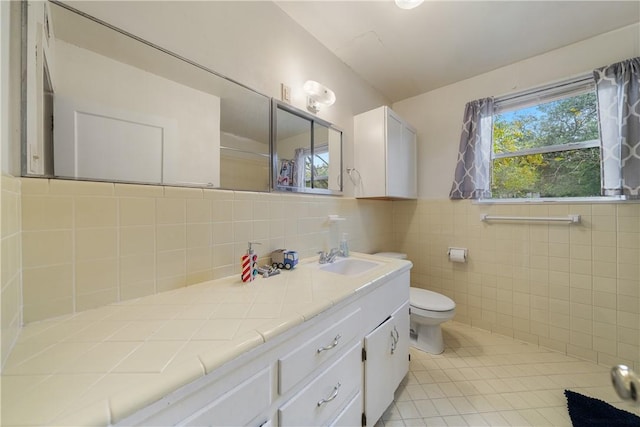 bathroom featuring tile walls, toilet, tile patterned floors, and vanity