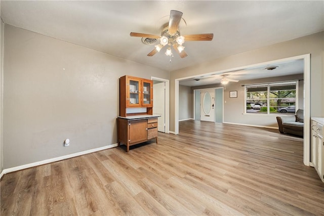 unfurnished living room featuring light hardwood / wood-style floors and ceiling fan