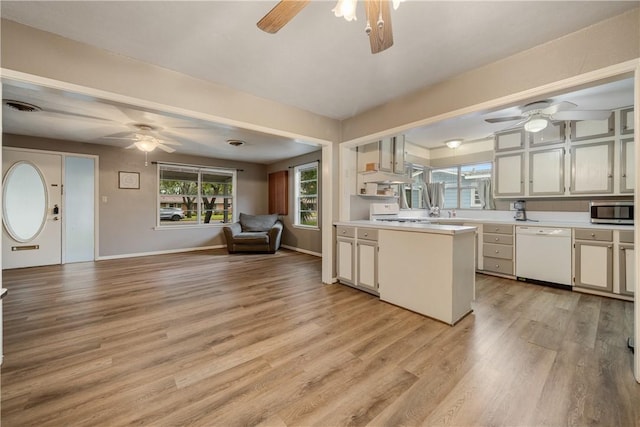 kitchen featuring dishwasher, kitchen peninsula, and light hardwood / wood-style flooring