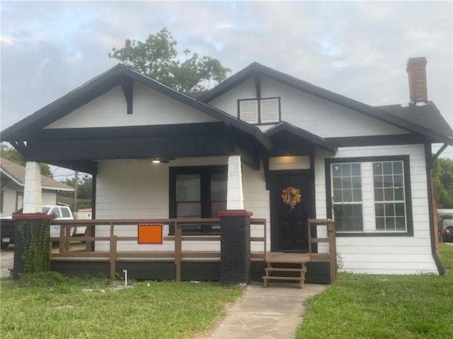 415 W King Ave, Kingsville, TX 78363 - bungalow-style house with a porch, a front lawn, and a chimney