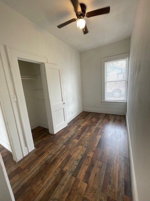 415 W King Ave, Kingsville, TX 78363 - unfurnished bedroom with dark wood-style floors, baseboards, ceiling fan, and a closet
