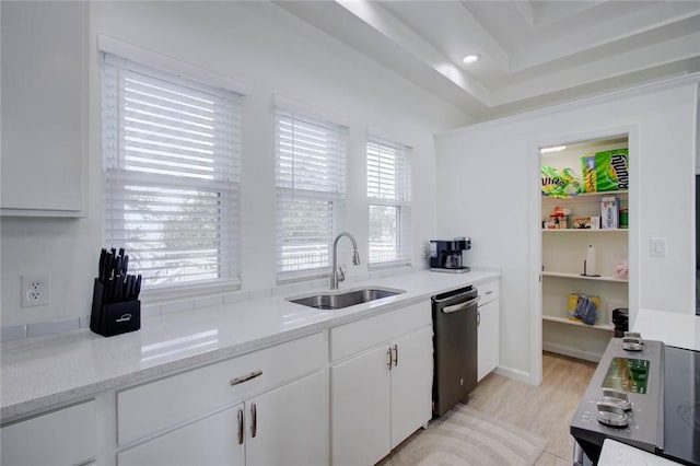 kitchen featuring white cabinets, sink, light hardwood / wood-style flooring, stainless steel dishwasher, and light stone counters