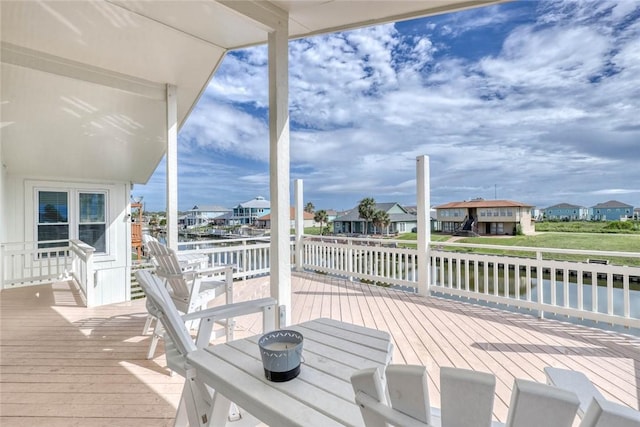 wooden terrace featuring a water view