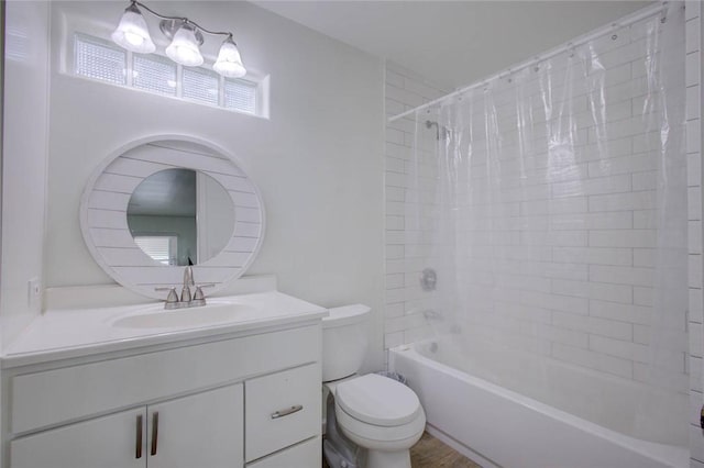 full bathroom featuring hardwood / wood-style floors, vanity, toilet, and shower / bath combo with shower curtain