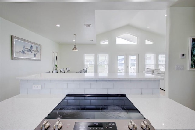 kitchen featuring pendant lighting, lofted ceiling, and range