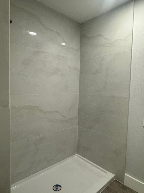 bathroom with a tile shower