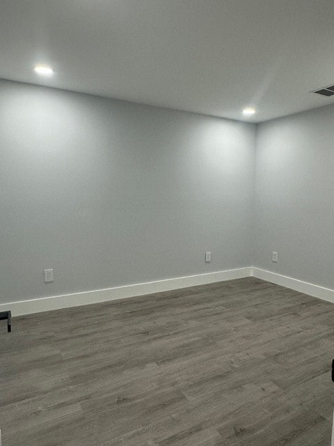 empty room with dark wood-type flooring