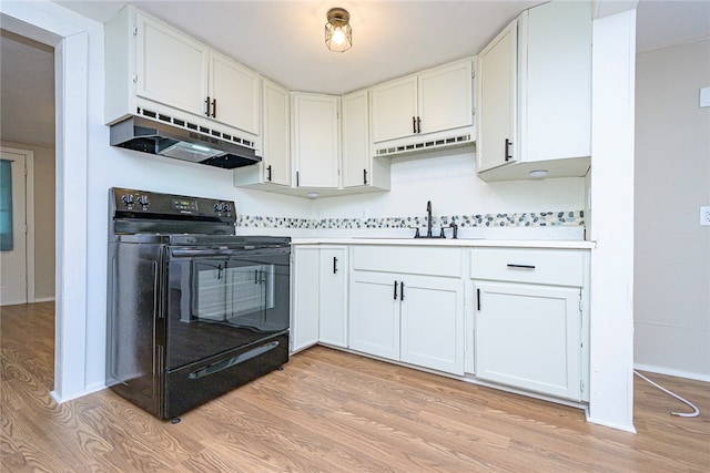 kitchen with light wood-type flooring, under cabinet range hood, a sink, and black electric range oven