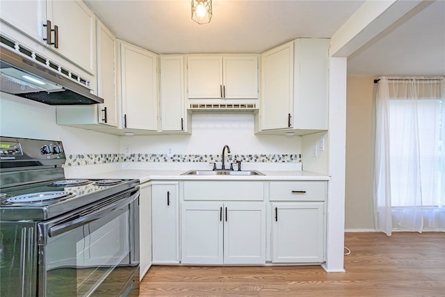 kitchen with white cabinets, light wood-type flooring, sink, and black range with electric stovetop