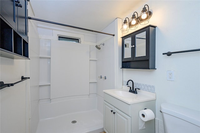 bathroom with toilet, vanity, and walk in shower