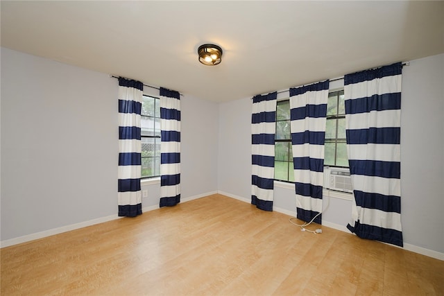 empty room with wood-type flooring and cooling unit