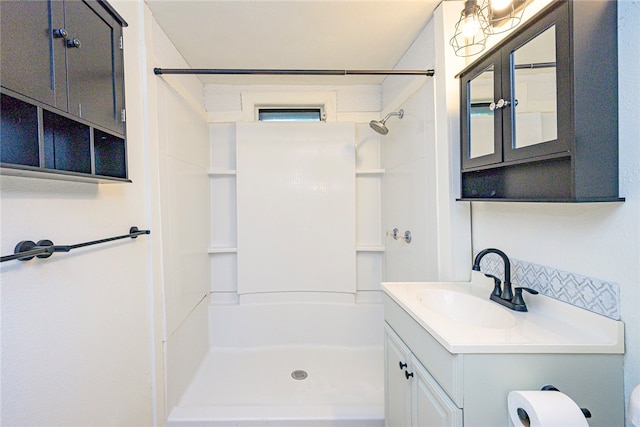 full bathroom with vanity, toilet, and walk in shower