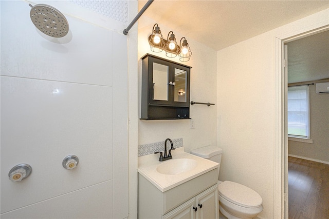 bathroom with toilet, vanity, hardwood / wood-style floors, and a textured ceiling