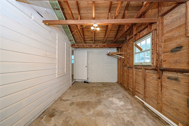 basement featuring wood walls