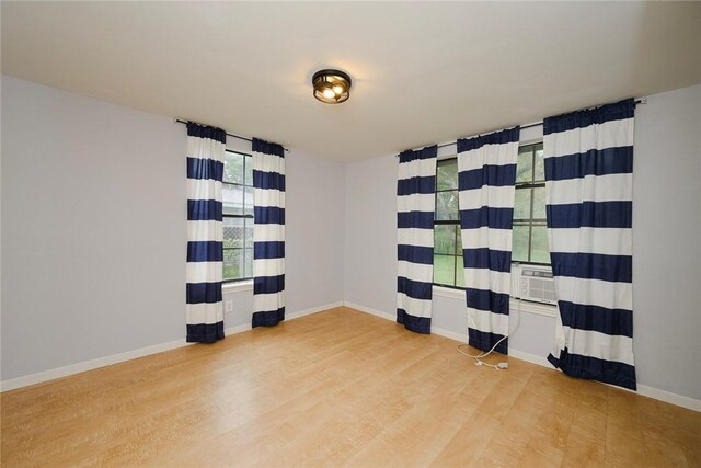 bathroom with toilet, a shower, vanity, and hardwood / wood-style flooring