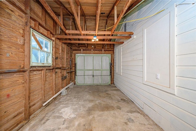 garage featuring wood walls