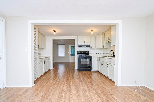 unfurnished living room with a textured ceiling and light wood-type flooring