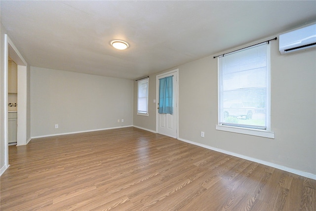 interior space featuring a wall mounted AC and light wood-type flooring