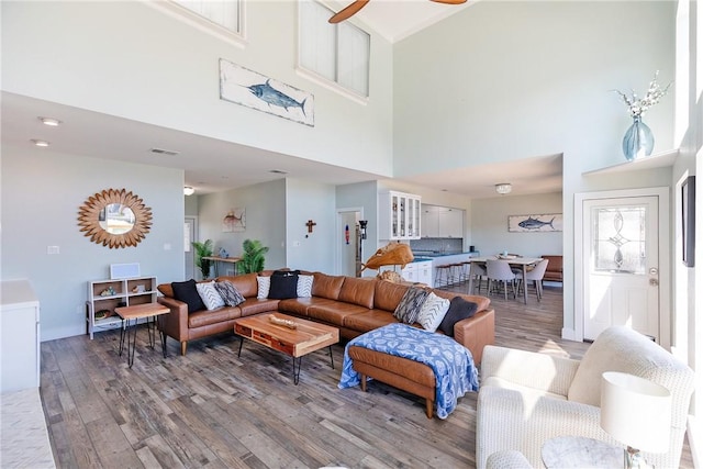 15354 Caravel Dr, Corpus Christi, TX 78418 - living room featuring light wood-style flooring, a high ceiling, baseboards, and a ceiling fan