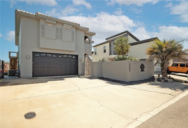 15354 Caravel Dr, Corpus Christi, TX 78418 - mediterranean / spanish-style house featuring cooling unit, a garage, driveway, and stucco siding