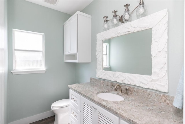 15354 Caravel Dr, Corpus Christi, TX 78418 - bathroom with vanity, toilet, wood finished floors, and baseboards