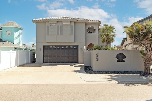 15354 Caravel Dr, Corpus Christi, TX 78418 - mediterranean / spanish-style home featuring an attached garage, concrete driveway, and stucco siding
