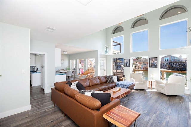 15354 Caravel Dr, Corpus Christi, TX 78418 - living room featuring dark wood-style floors, baseboards, and a towering ceiling