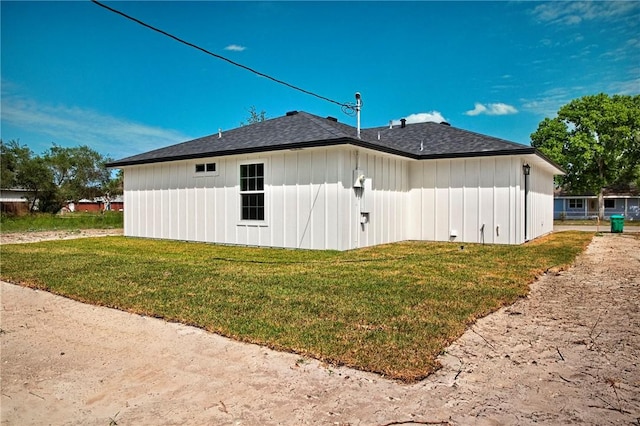 936 S 10th St, Aransas Pass, TX 78336 - view of side of property featuring a lawn, board and batten siding, and roof with shingles