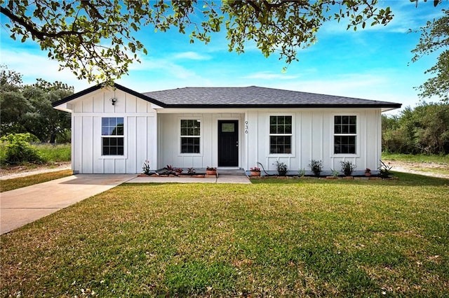 936 S 10th St, Aransas Pass, TX 78336 - view of front of property featuring roof with shingles, a front yard, and board and batten siding