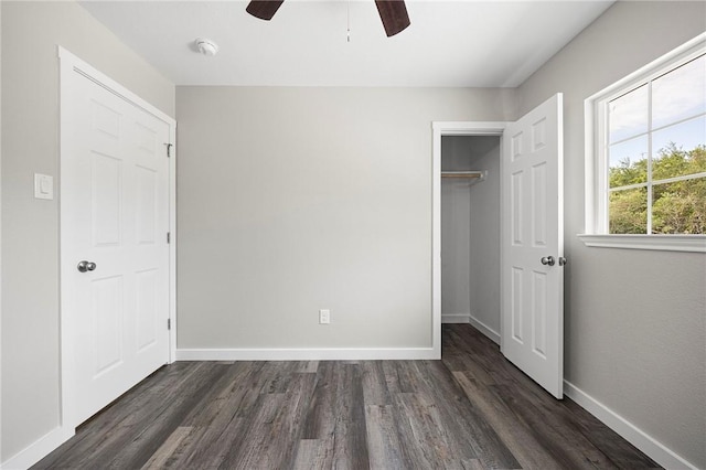 936 S 10th St, Aransas Pass, TX 78336 - unfurnished bedroom with baseboards, a spacious closet, a closet, and dark wood-style floors