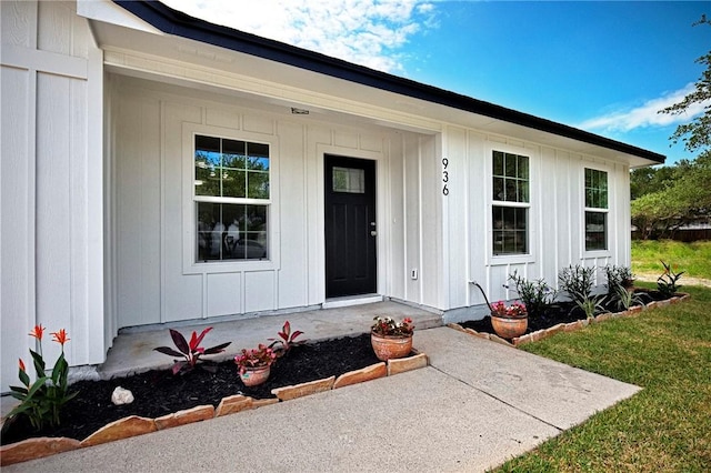 936 S 10th St, Aransas Pass, TX 78336 - property entrance with covered porch, board and batten siding, and a yard