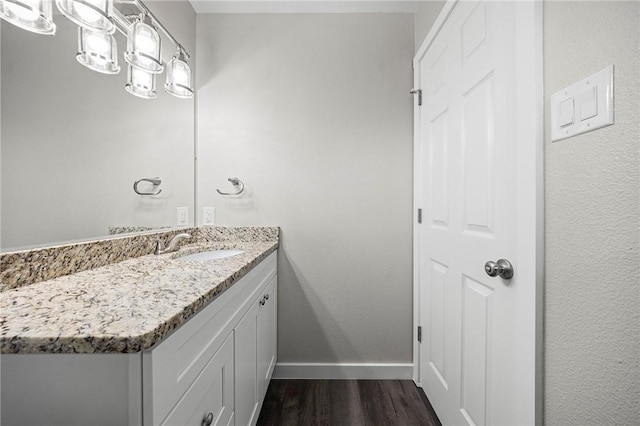 936 S 10th St, Aransas Pass, TX 78336 - bathroom featuring vanity, wood finished floors, and baseboards