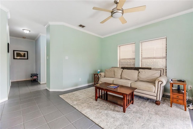 living room featuring visible vents, a ceiling fan, ornamental molding, tile patterned flooring, and baseboards