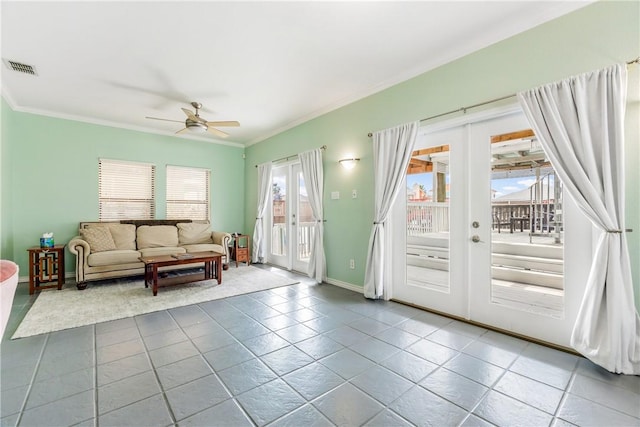 tiled living area with ceiling fan, visible vents, baseboards, ornamental molding, and french doors