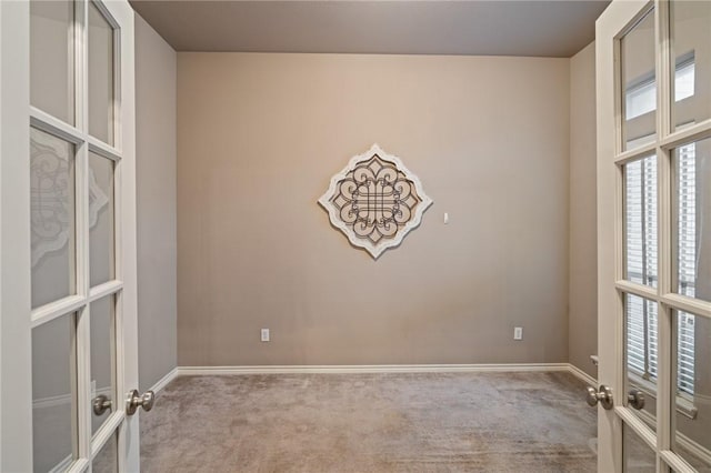 carpeted empty room with french doors