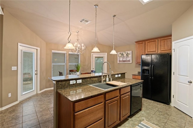 kitchen featuring vaulted ceiling, hanging light fixtures, an island with sink, black appliances, and sink