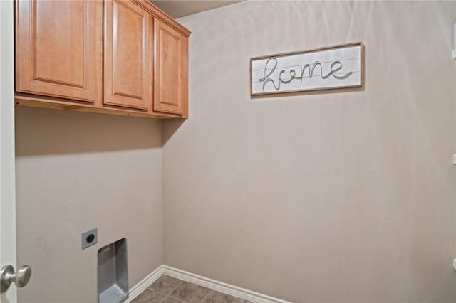 laundry room with electric dryer hookup and cabinets