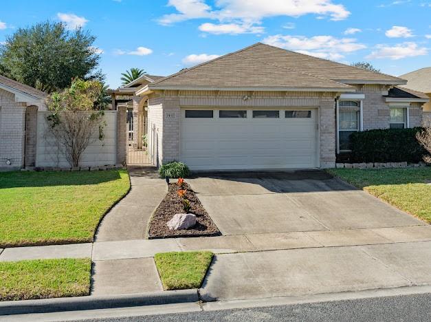 ranch-style house with a front lawn and a garage