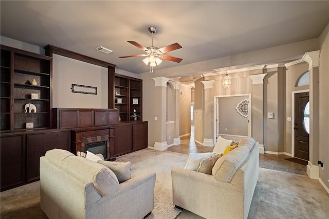 living room featuring ceiling fan and ornate columns